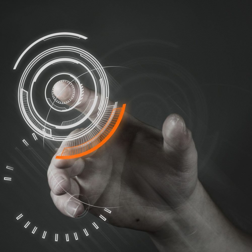 A man touching a futuristic button.